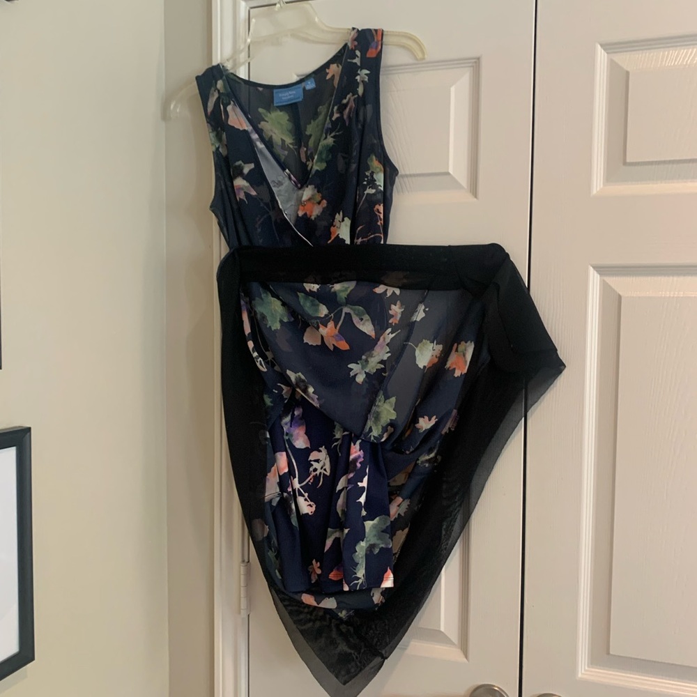 Classy, sassy cocktail dress. Asymmetrical hemline is trimmed with 4” in black.